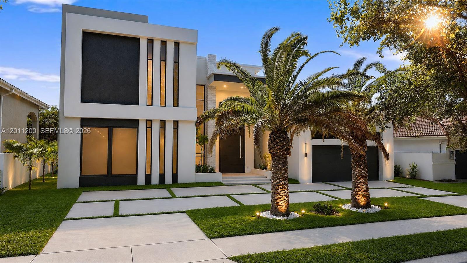 A modern two-story house features a white facade, dark accents, and two palm trees — 16022 NW 83rd Ct, Miami Lakes FL 33016, MIAMI LAKES, FL