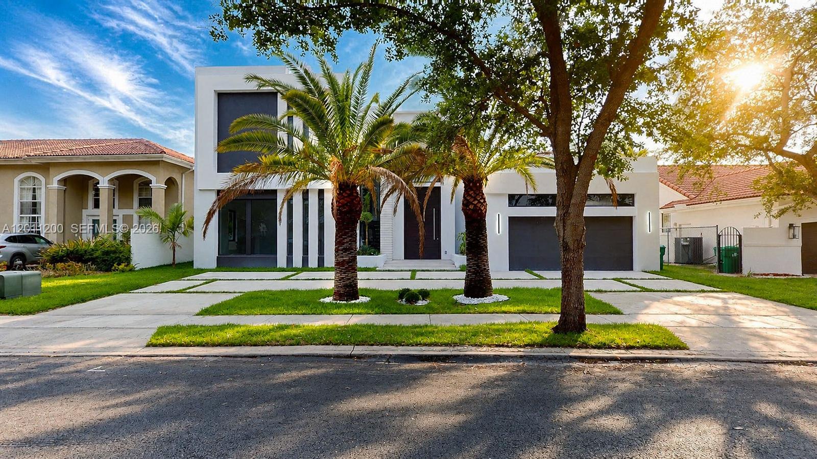 A modern two-story house with a flat roof, palm trees, and a paved driveway — 16022 NW 83rd Ct, Miami Lakes FL 33016, MIAMI LAKES, FL