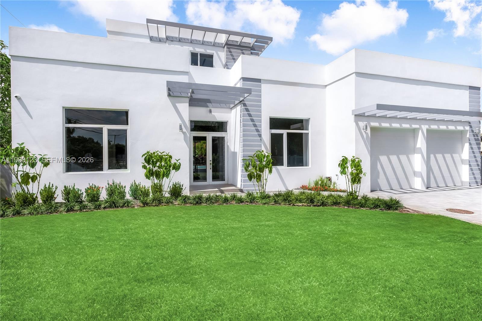 A modern white house with a flat roof, gray accents, and a two-car garage — 9895 NW 26th St, Doral FL 33172, DORAL, FL