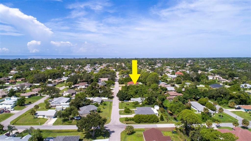 An aerial view shows a residential neighborhood with a yellow arrow pointing to a house — MISSOURI ROAD, VENICE, FL