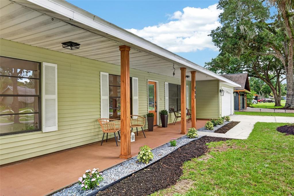 A single-story house with light green siding, a covered front porch, and a grassy lawn — 485 MERRIMAC DRIVE, PORT ORANGE, FL