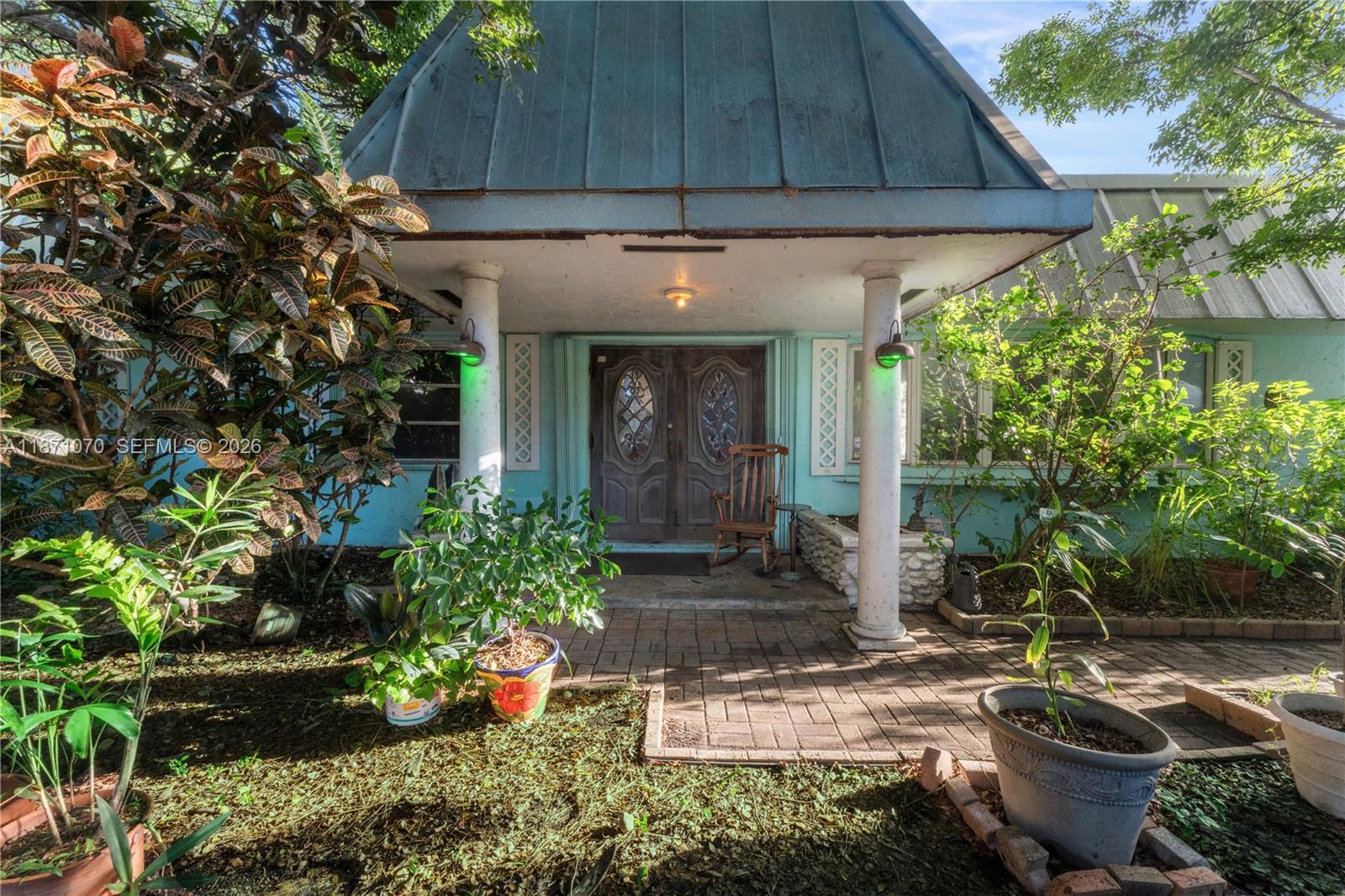 The front entrance features a covered porch with two white columns and double wooden doors — 3260 Lakeview Dr, Pompano Beach FL 33062, POMPANO BEACH, FL