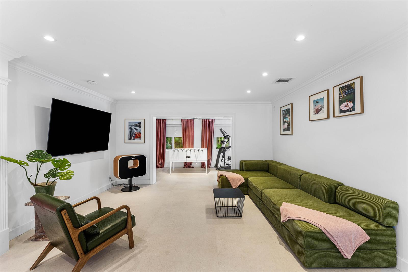 A living room features a green sectional sofa, a matching armchair, and a foosball table — 247 SE 3rd Avenue, Delray Beach FL 33483, DELRAY BEACH, FL