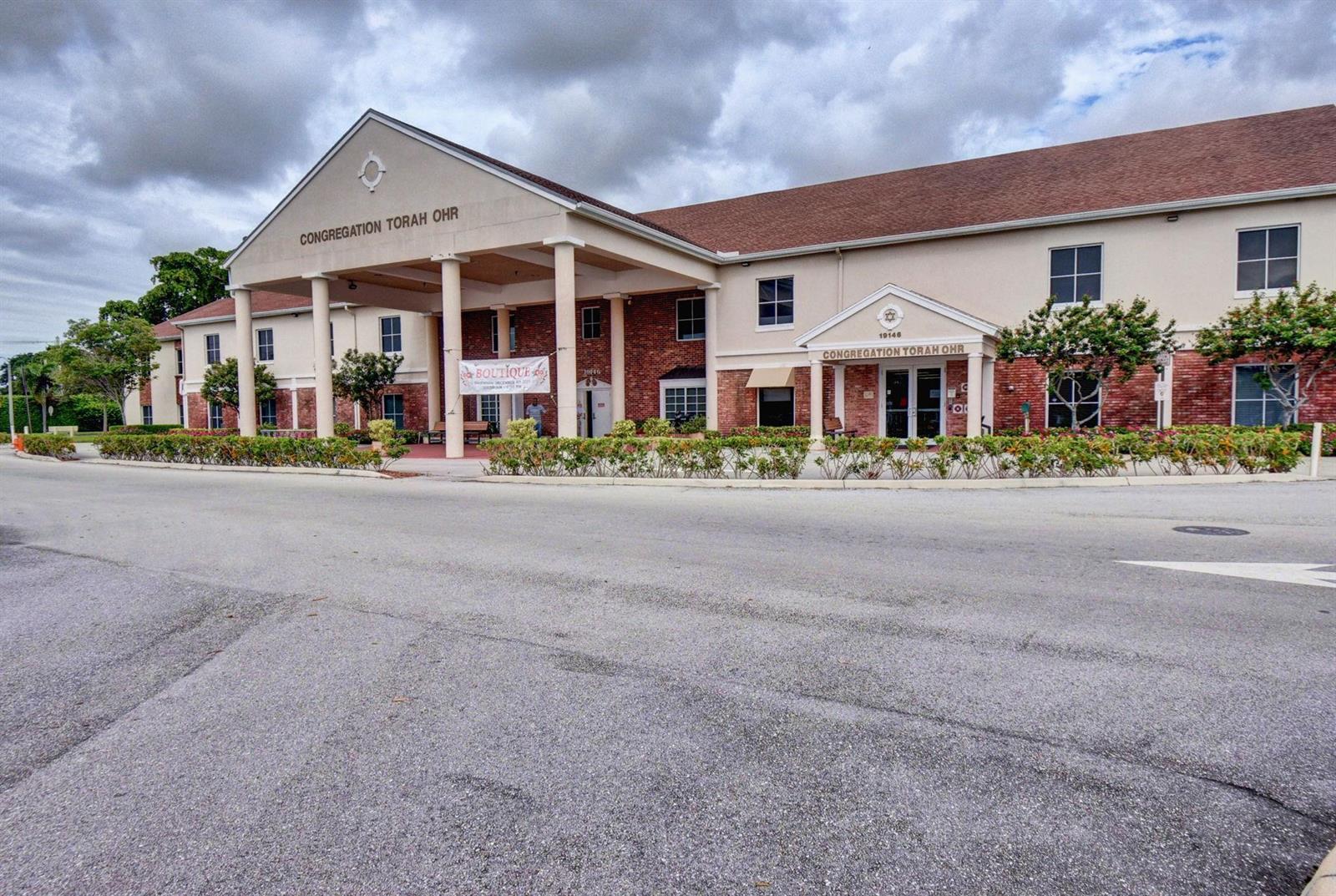 A two-story building with a large covered entrance and brick accents under a cloudy sky — 3025 Guildford B # 3025, Boca Raton FL 33434, BOCA RATON, FL