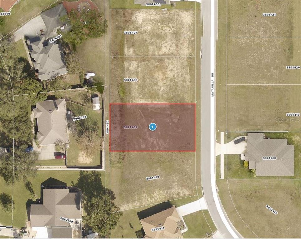 This is an aerial map showing a vacant rectangular lot highlighted in red — 11623 MATANILLA DRIVE, CLERMONT, FL