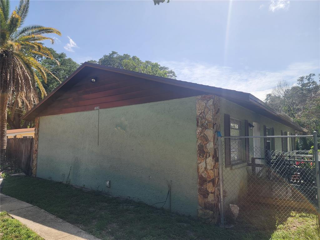 A laundry closet with tile flooring, water hookups, a drain pipe, and electrical outlets — 10020 N HYACINTH AVENUE, TAMPA, FL