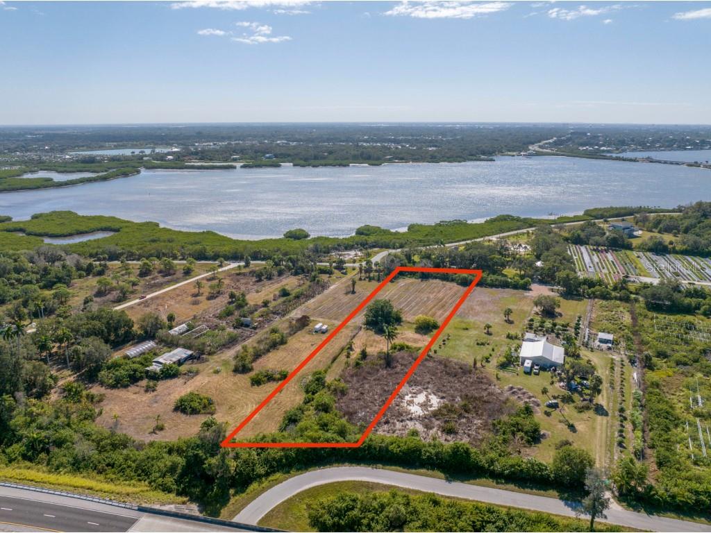 An aerial view shows a rectangular plot of land outlined in red near a body of water — 282 TERRA CEIA ROAD, PALMETTO, FL