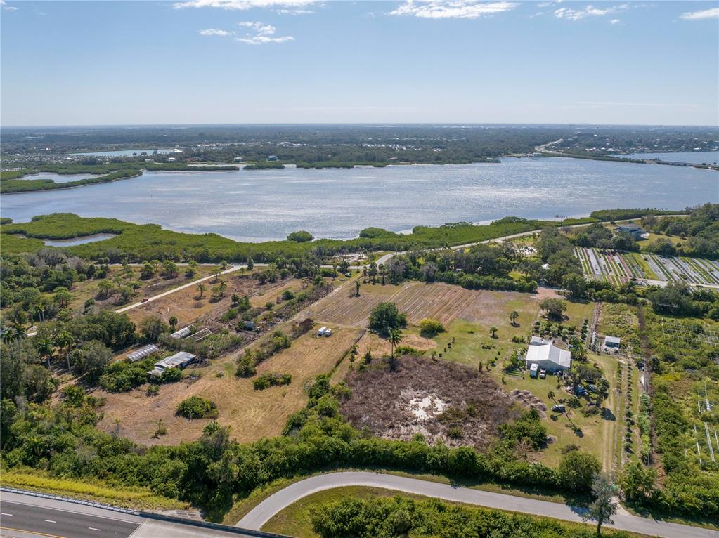 An aerial view shows a large plot of land with buildings near a coastal waterway — 282 TERRA CEIA ROAD, PALMETTO, FL