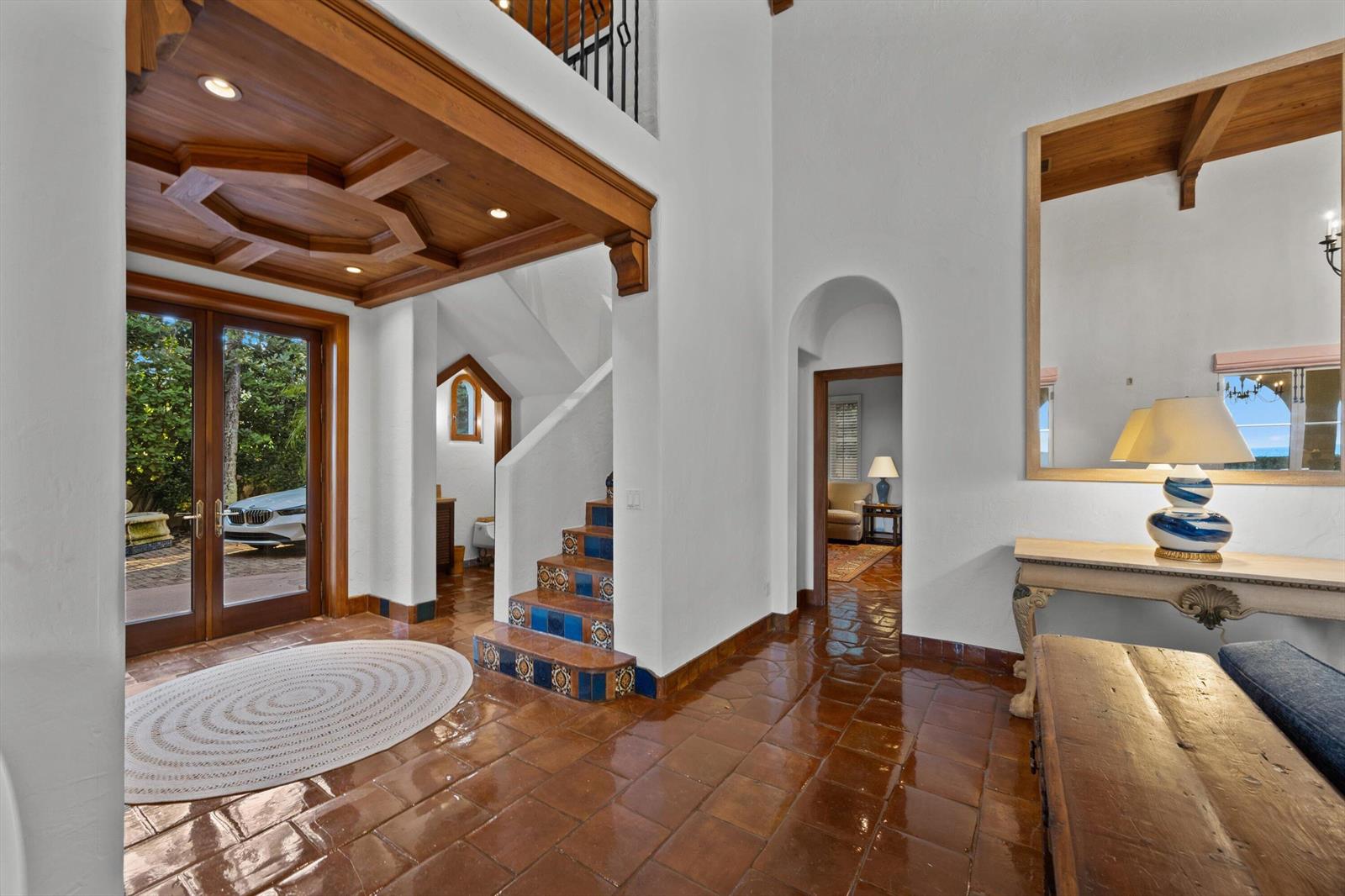 An entryway features terracotta tile floors, a coffered wood ceiling, and a tiled staircase — 240 N Ocean Boulevard, Palm Beach FL 33480, PALM BEACH, FL