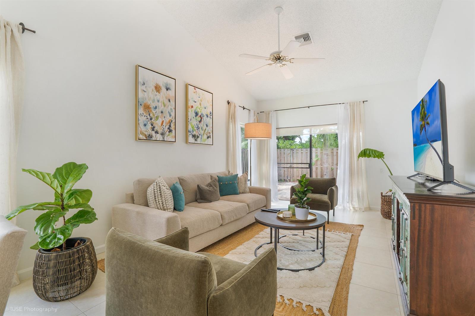 A bright living room features a beige sofa, two armchairs, a coffee table, and a television — 21712 Wapford Way, Boca Raton FL 33486, BOCA RATON, FL