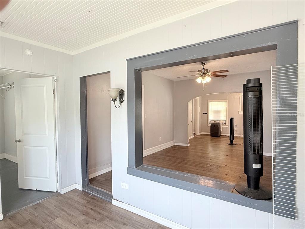 A view through a large rectangular opening into an adjacent room with wood-look flooring — 1933 47TH STREET S, ST PETERSBURG, FL
