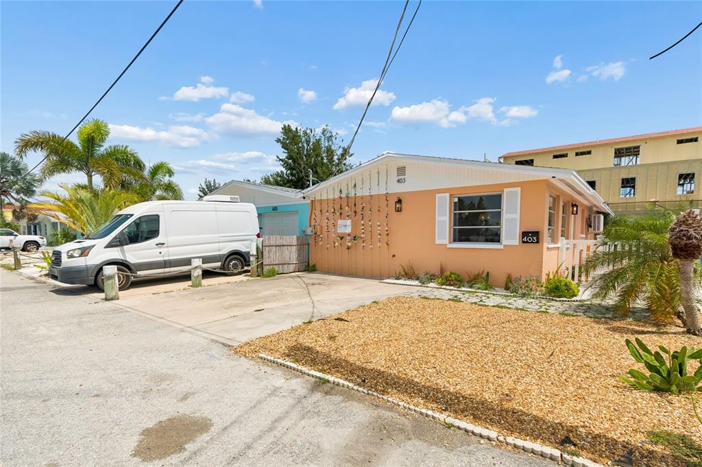 A peach-colored house with a gravel front yard and a white van parked alongside — 403 63RD STREET, HOLMES BEACH, FL