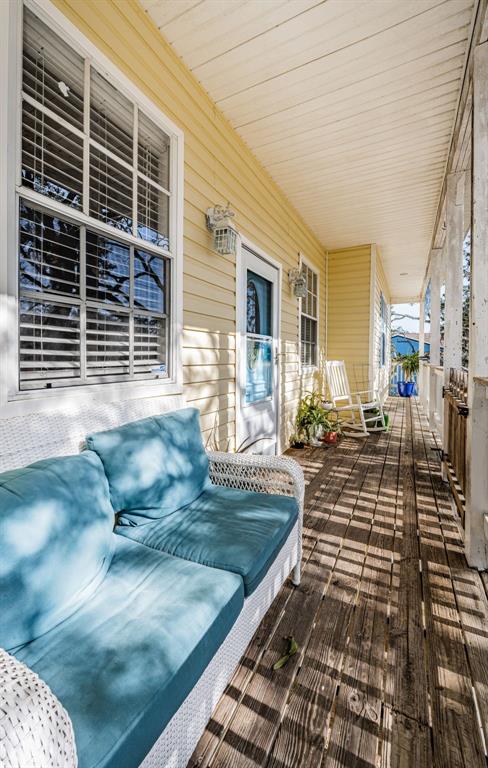A kitchen features white cabinetry, stainless steel appliances, light blue walls, and wood-look tile flooring — 5127 BAY BOULEVARD, PORT RICHEY, FL