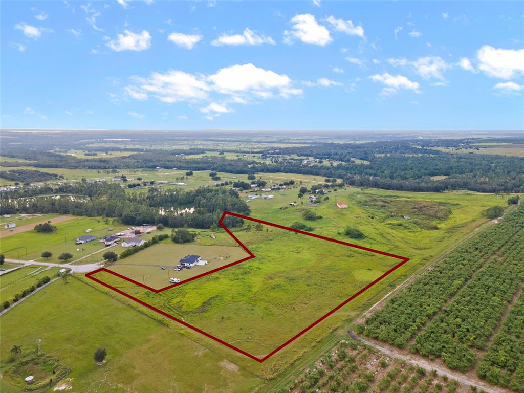 An aerial view shows a large, grassy plot of land outlined in red — BROOKE LAKES DRIVE, FORT MEADE, FL
