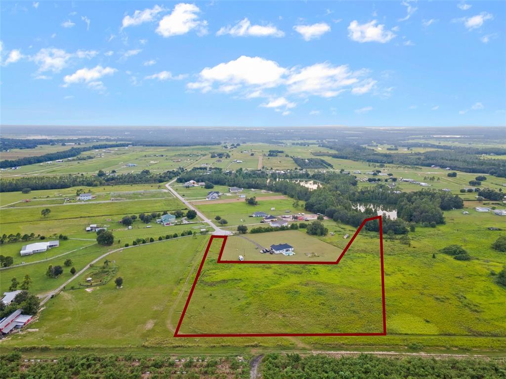 An aerial view shows a large, grassy plot of land outlined in red — BROOKE LAKES DRIVE, FORT MEADE, FL