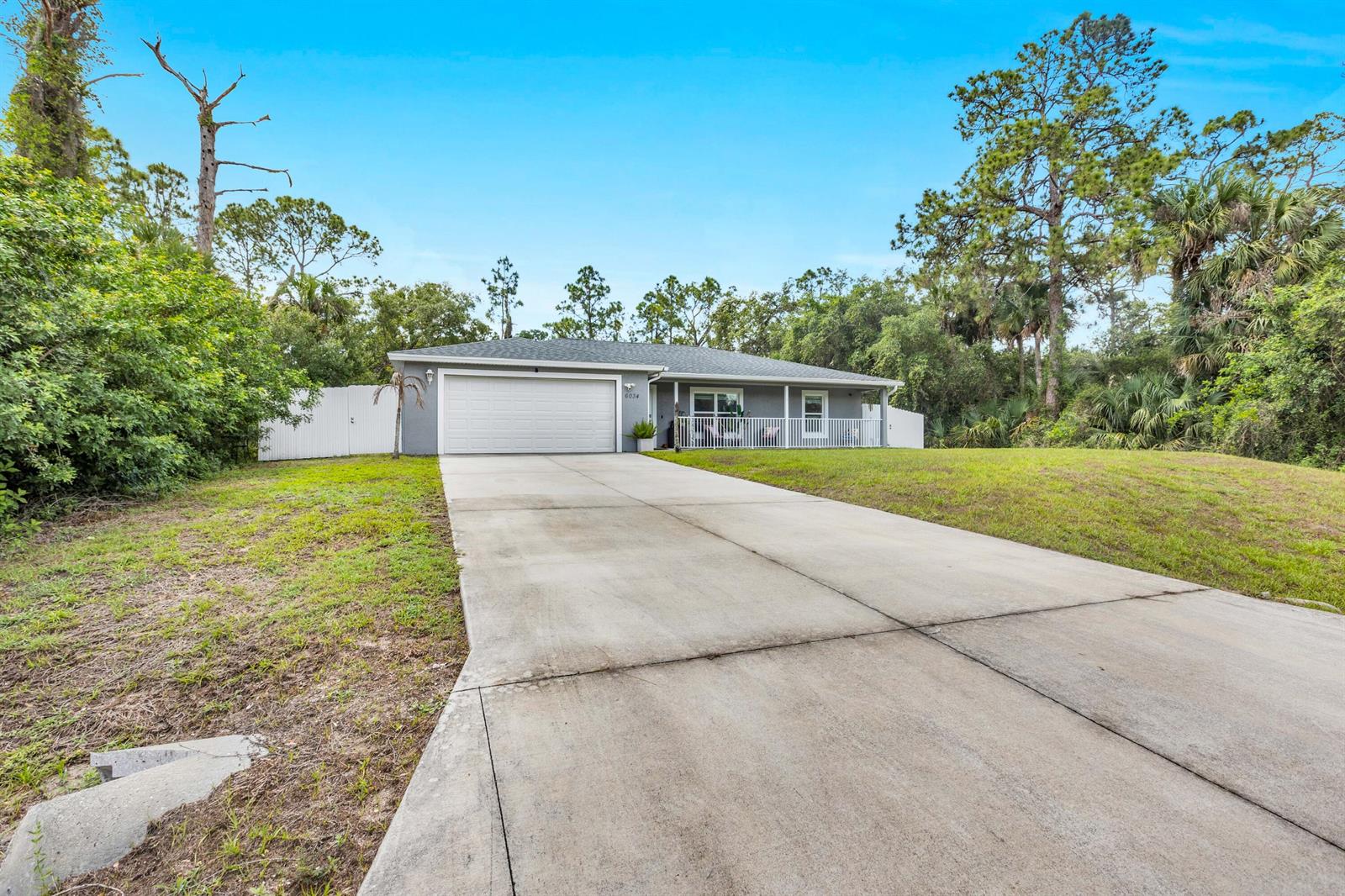 A single-story gray house with a two-car garage and a front porch — 6034 Twig Court, FL 33935, FL
