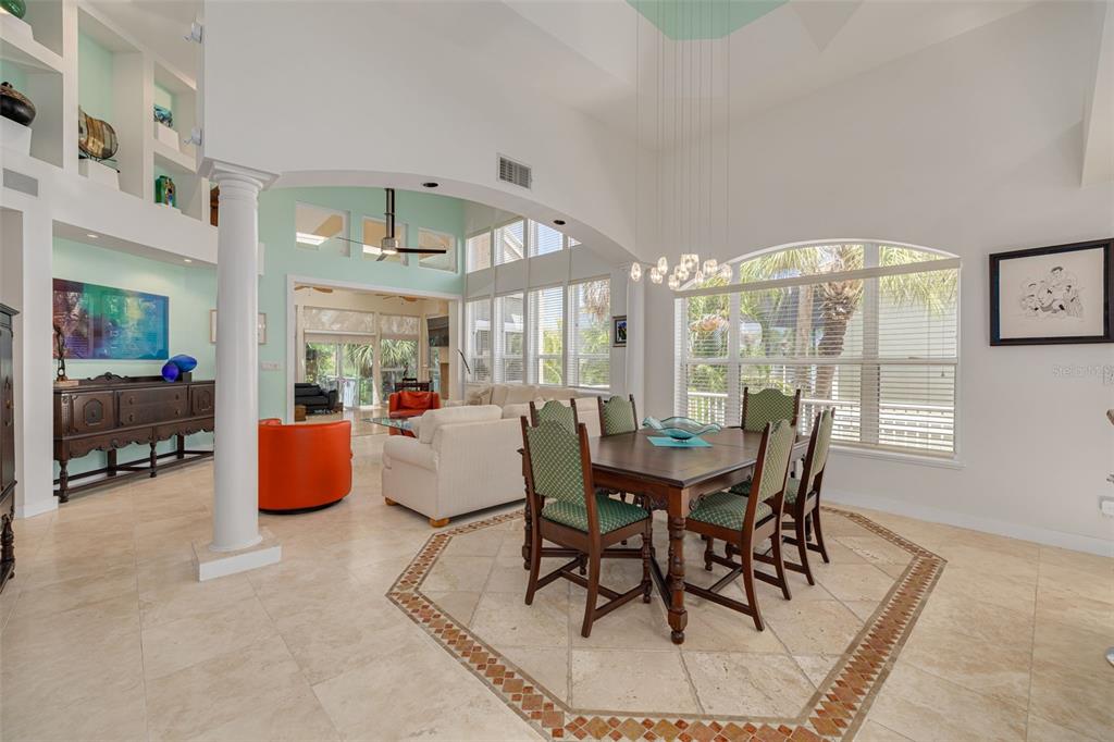 A dining room with a wooden table and chairs sits adjacent to an open kitchen — 2613 59TH STREET S, GULFPORT, FL