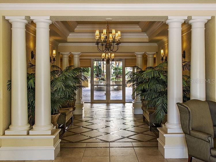 A formal lobby features white columns, a chandelier, potted plants, and a tiled floor — 1064 N TAMIAMI TRAIL UNIT 1635, SARASOTA, FL