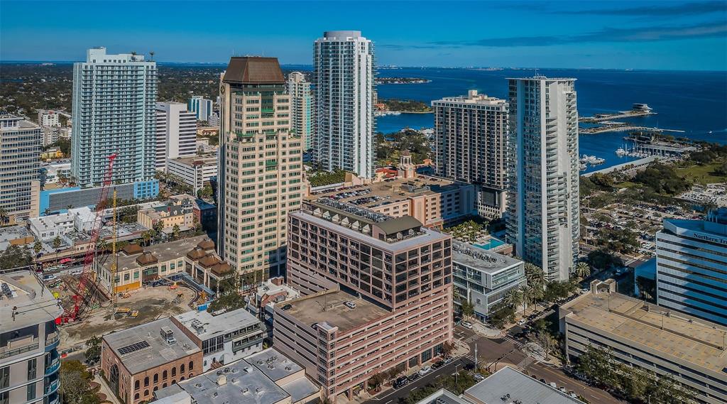 An aerial view of a dense urban skyline featuring high-rise buildings and a construction site — 175 2ND STREET S UNIT P04, ST PETERSBURG, FL