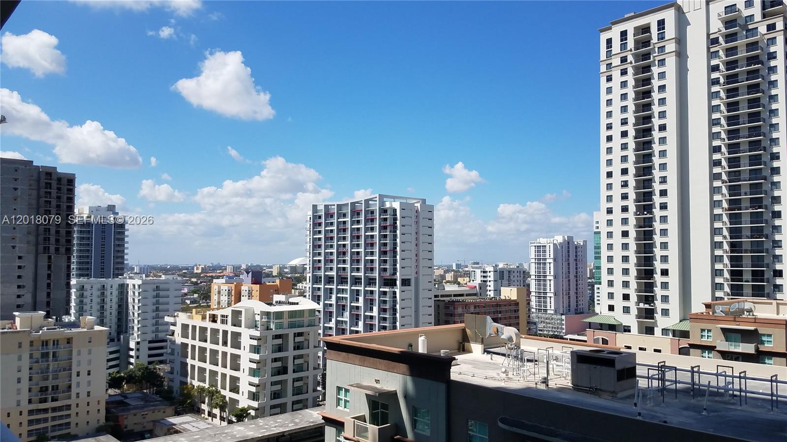 An elevated view of a city skyline featuring multiple high-rise apartment buildings under a blue sky — 1111 SW 1st Ave, Miami FL 33130, MIAMI, FL