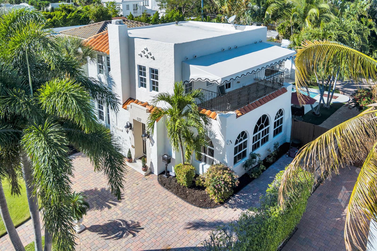 An aerial view of a white two-story stucco house with a balcony and palm trees — 137 Edgewood Drive, West Palm Beach FL 33405, WEST PALM BEACH, FL