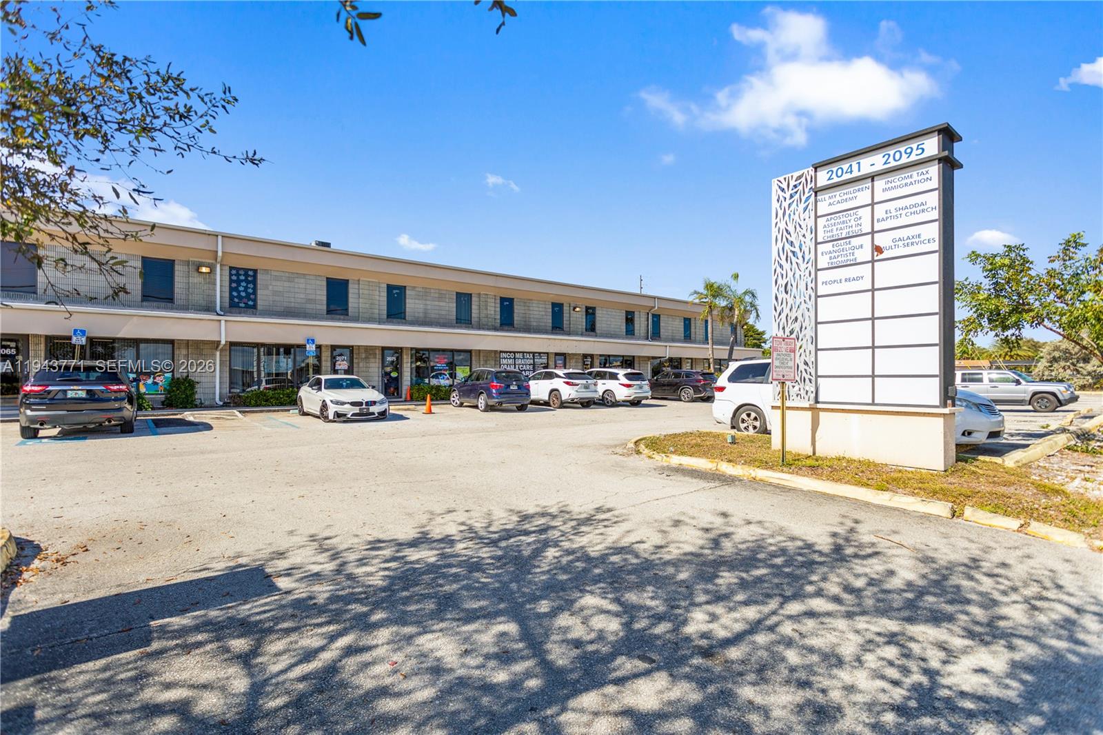 A two-story commercial building with a parking lot and a directory sign in front — 2025 N Dixie Hwy, Pompano Beach FL 33060, POMPANO BEACH, FL