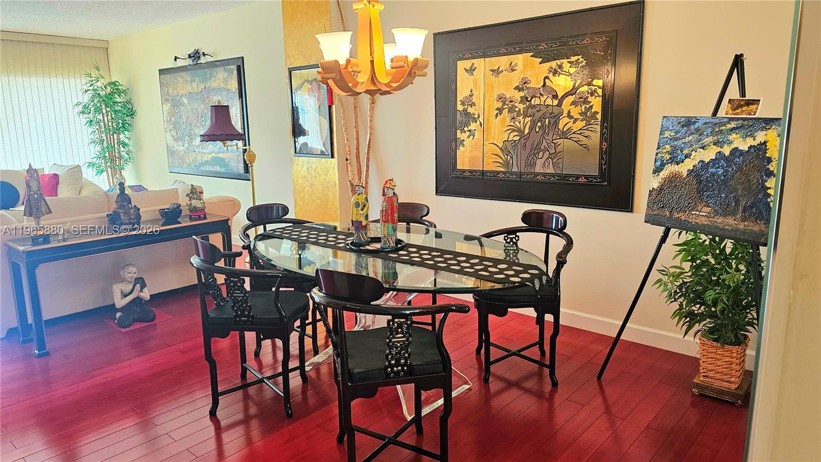A dining room features a glass-topped table, dark wooden chairs, and Asian-inspired wall art — 1985 S Ocean Dr # 10J, Hallandale Beach FL 33009, HALLANDALE BEACH, FL