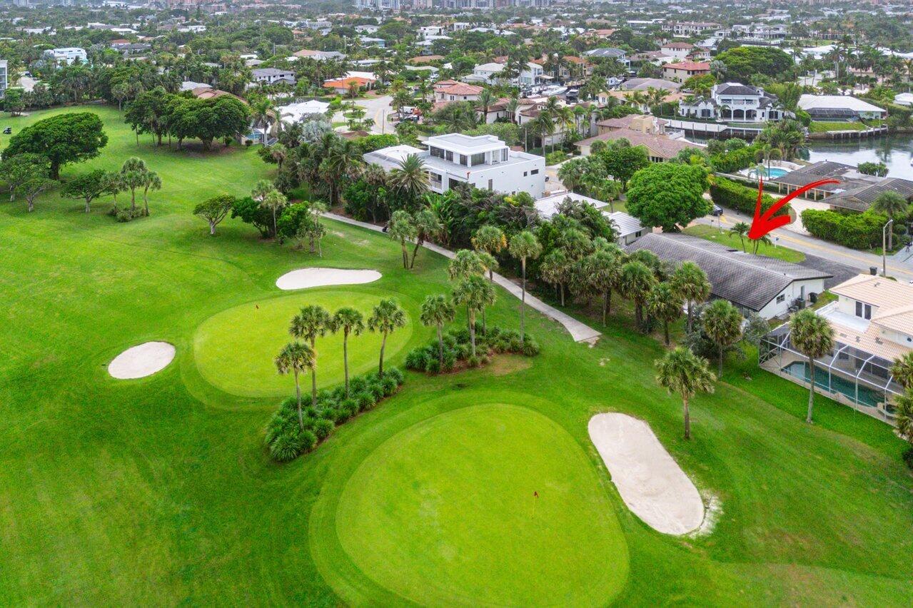 An aerial view shows a golf course green adjacent to a residential neighborhood and homes — 900 Marble Way, Boca Raton FL 33432, BOCA RATON, FL