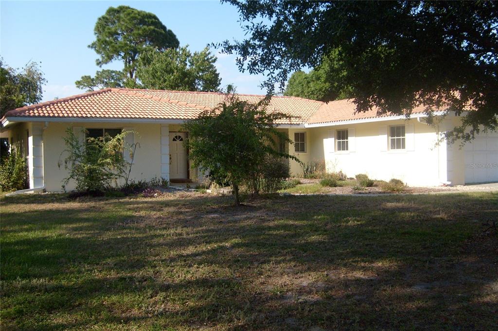 A single-story house with a light-colored exterior and a terracotta tile roof — 1876 MID OCEAN CIRCLE, SARASOTA, FL