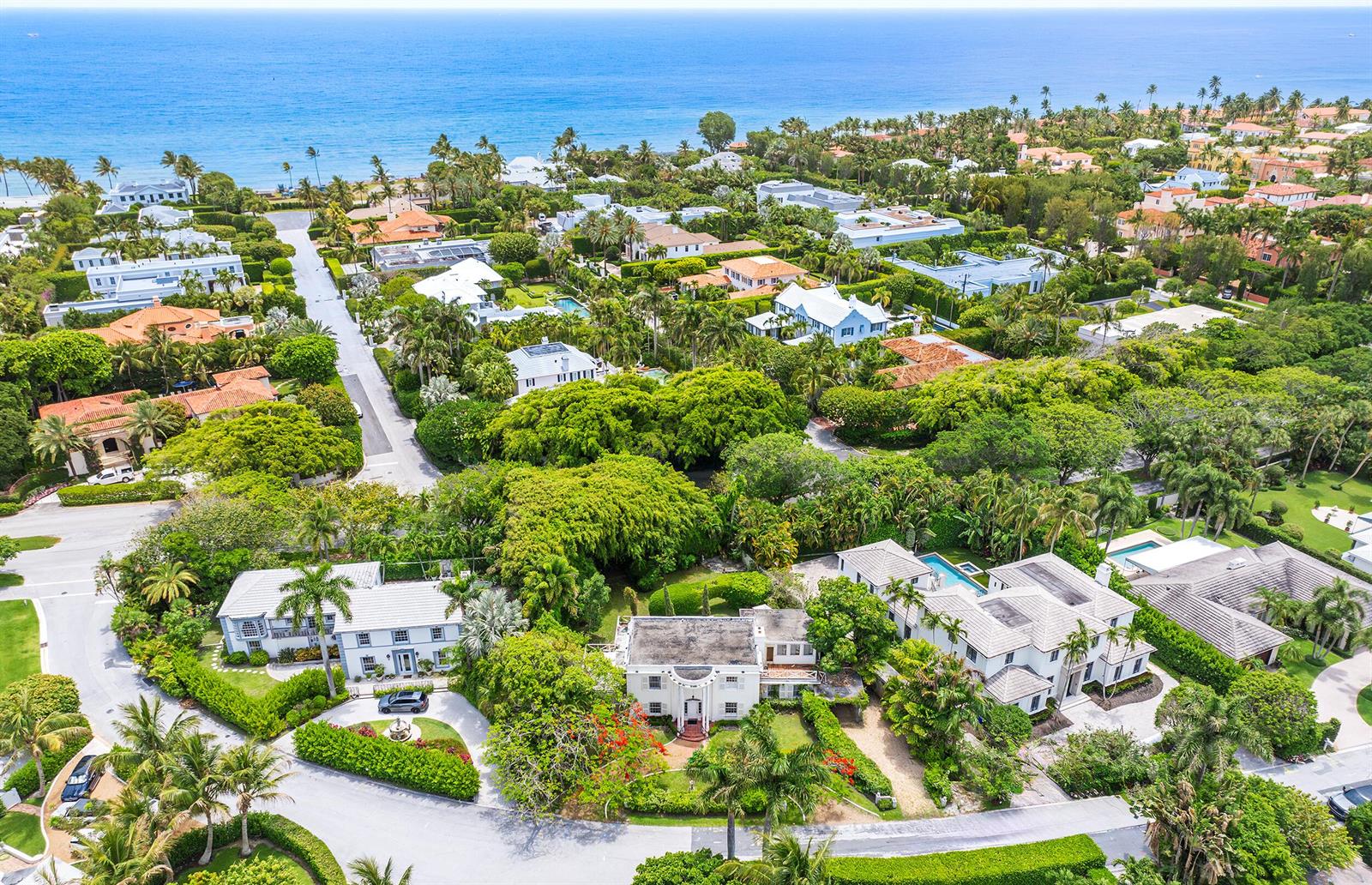 An aerial view shows several large houses surrounded by lush trees near the ocean — 357 Crescent Drive, Palm Beach FL 33480, PALM BEACH, FL