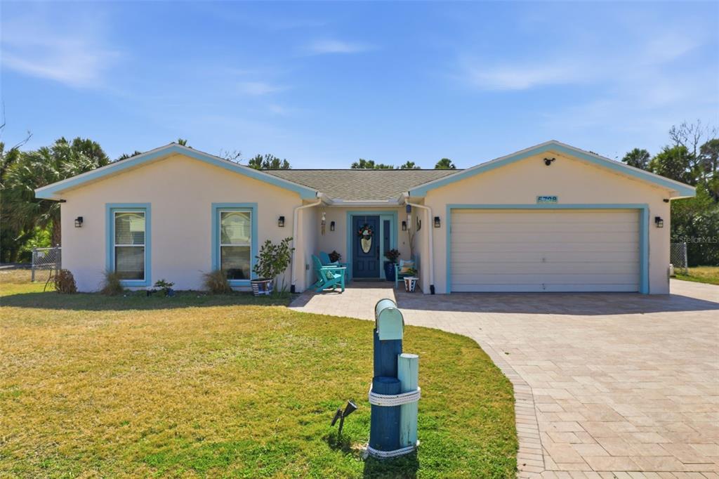 A single-story house with a light-colored exterior, blue trim, and a paved driveway — 5728 SEABREEZE DRIVE, PORT RICHEY, FL