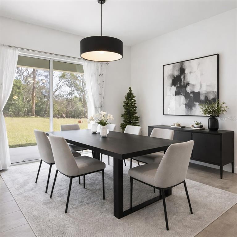 A dining room features a black table, light gray chairs, and a large sliding glass door — 827 DENNIS AVENUE, ORLANDO, FL