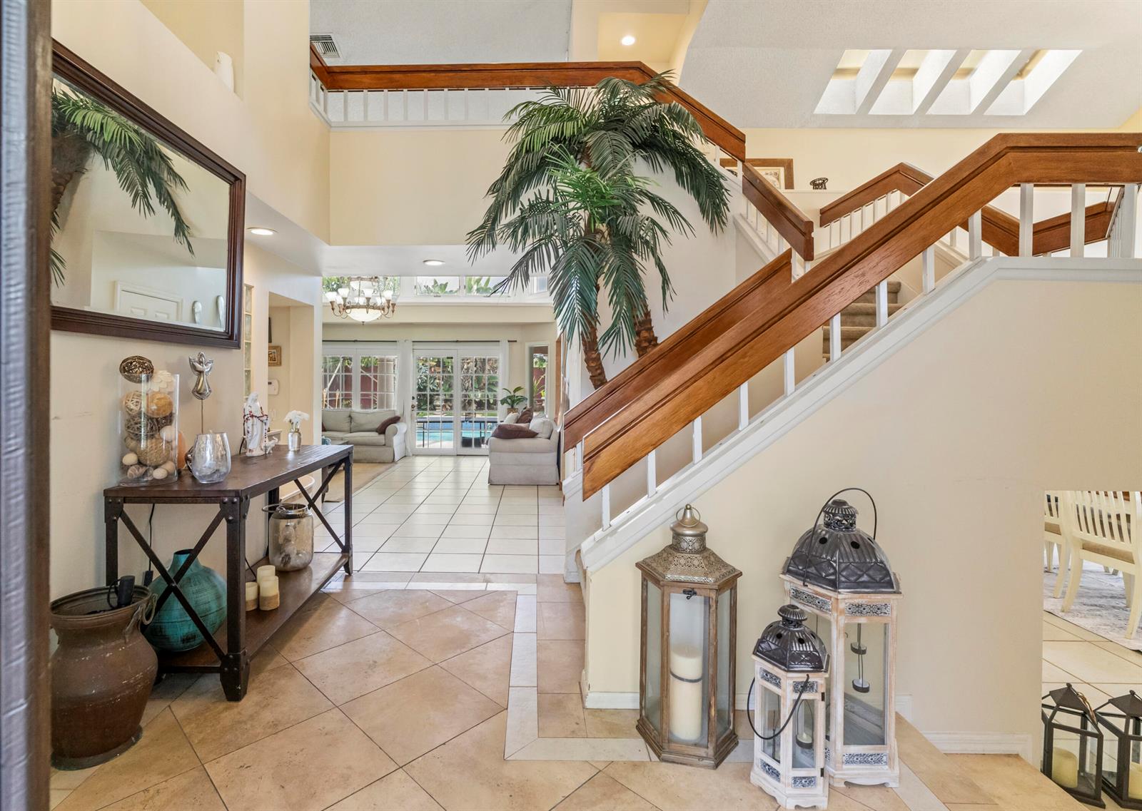 A screened-in swimming pool with a tiled deck and stone columns under a metal frame — 2683 NW 49th Street, Boca Raton FL 33434, BOCA RATON, FL