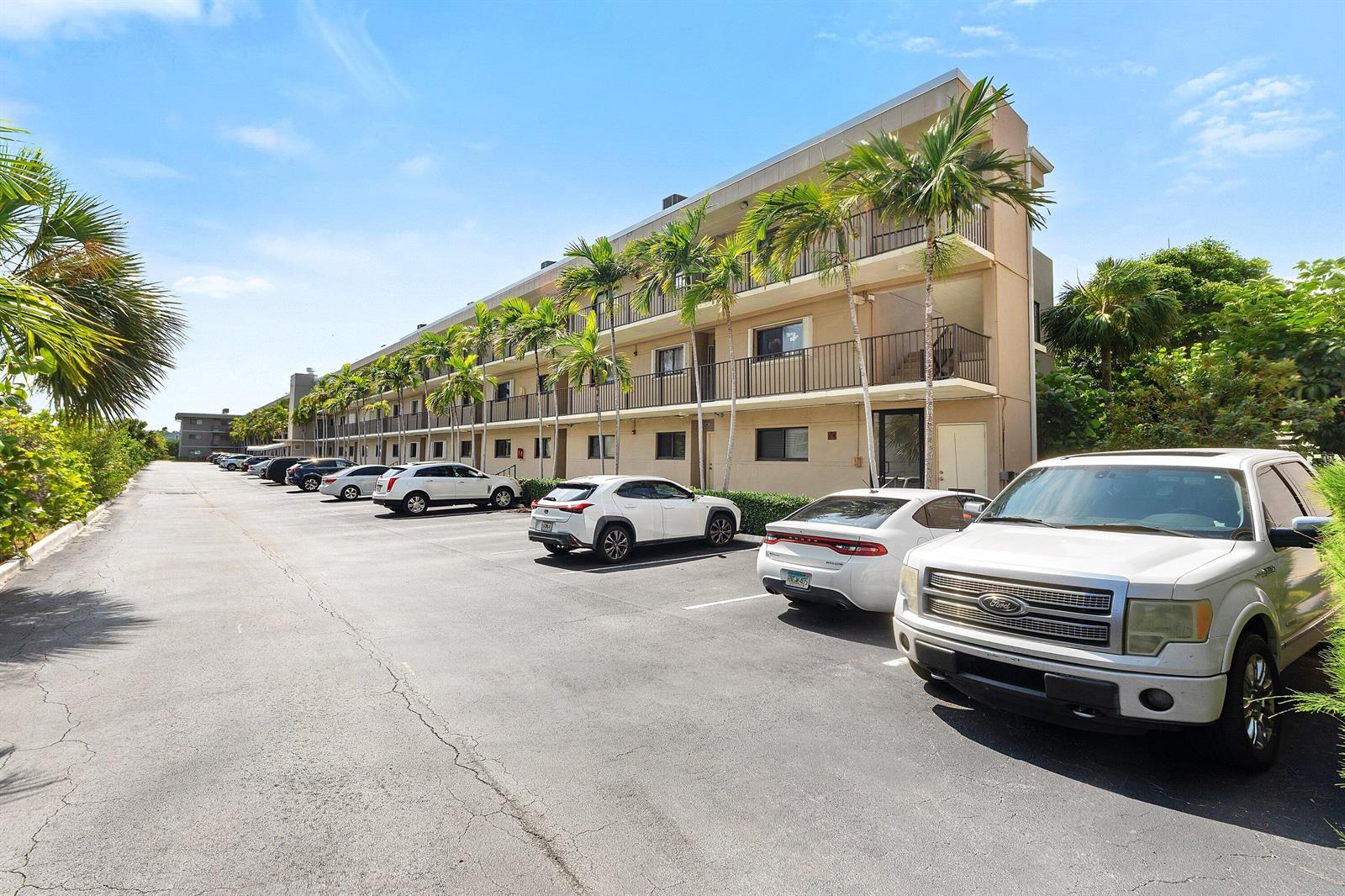 A multi-story apartment building with a parking lot in front and palm trees — 3605 S Ocean Boulevard, South Palm Beach FL 33480, SOUTH PALM BEACH, FL