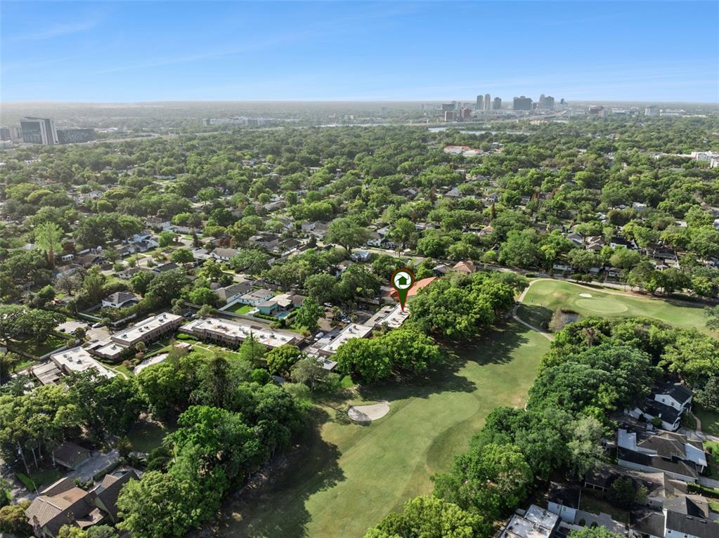 An aerial view shows a residential complex situated next to a golf course — 3104 HARRISON AVENUE UNIT 33, ORLANDO, FL