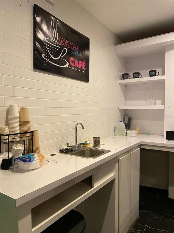 A small kitchen area features a sink, white subway tile backsplash, and a cafe sign — 88 CALLE REINA ST, PONCE, PR
