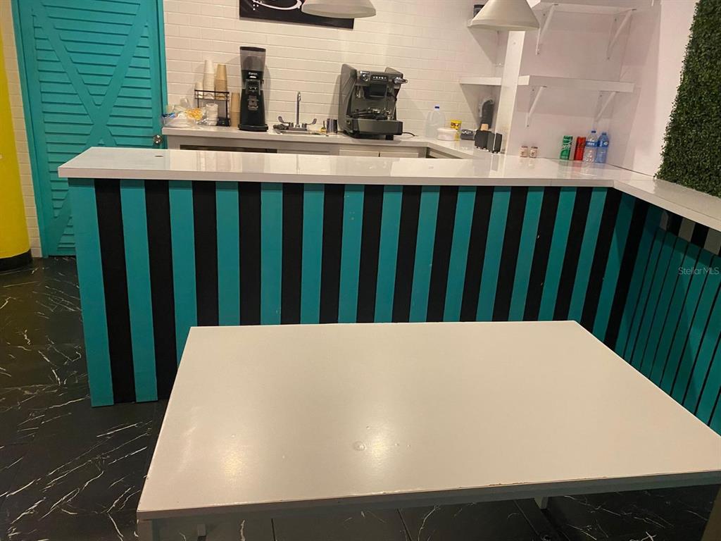 A coffee bar area features a white countertop, turquoise and black striped base, and appliances — 88 CALLE REINA ST, PONCE, PR