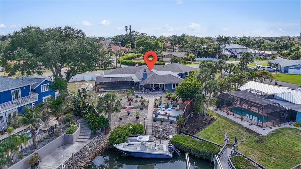 An aerial view of a waterfront house with a boat docked in the canal — 314 S SHORE DRIVE, OSPREY, FL
