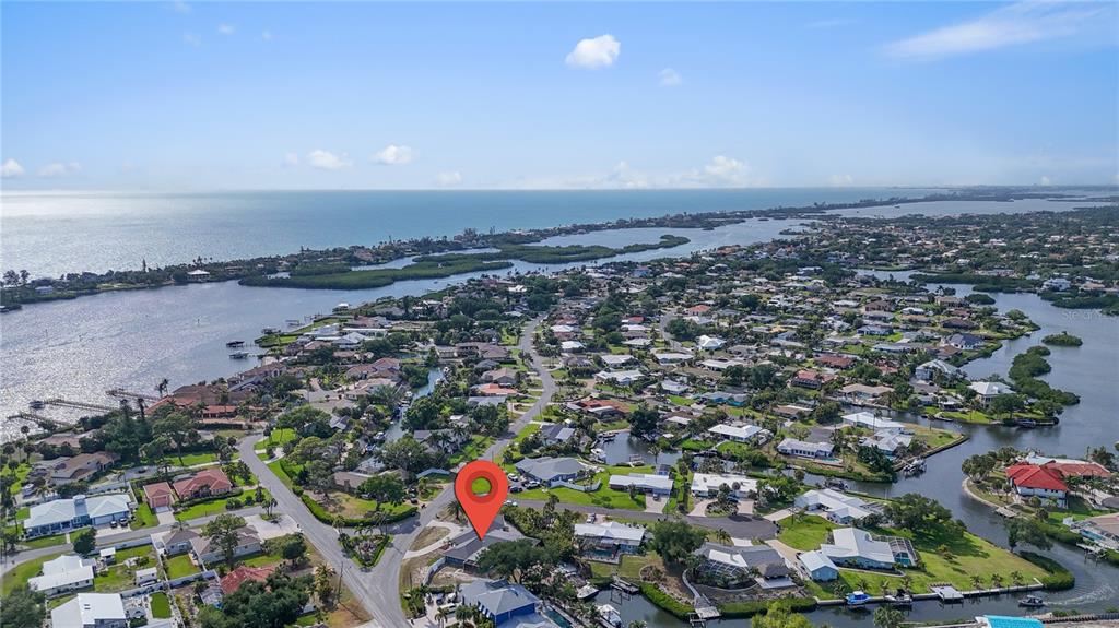 An aerial view shows a residential neighborhood with a red location pin on a house — 314 S SHORE DRIVE, OSPREY, FL