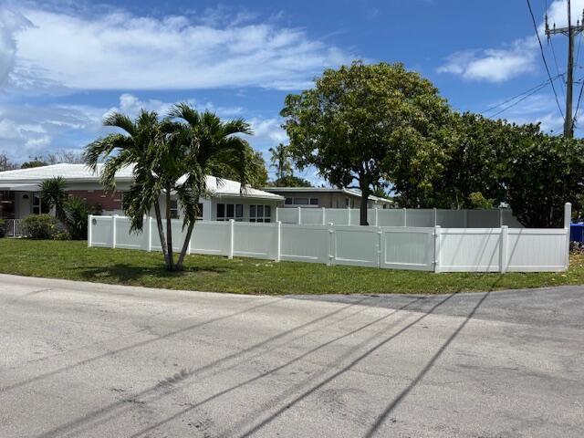 A white vinyl fence encloses the yard of a single-story house with palm trees — 1107 S 15th Avenue, Hollywood FL 33020, HOLLYWOOD, FL
