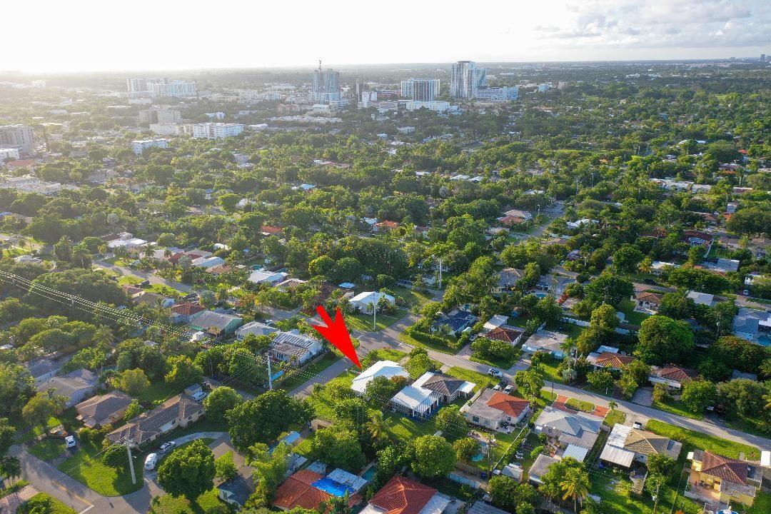 An aerial view of a suburban neighborhood with a red arrow pointing to a house — 1107 S 15th Avenue, Hollywood FL 33020, HOLLYWOOD, FL