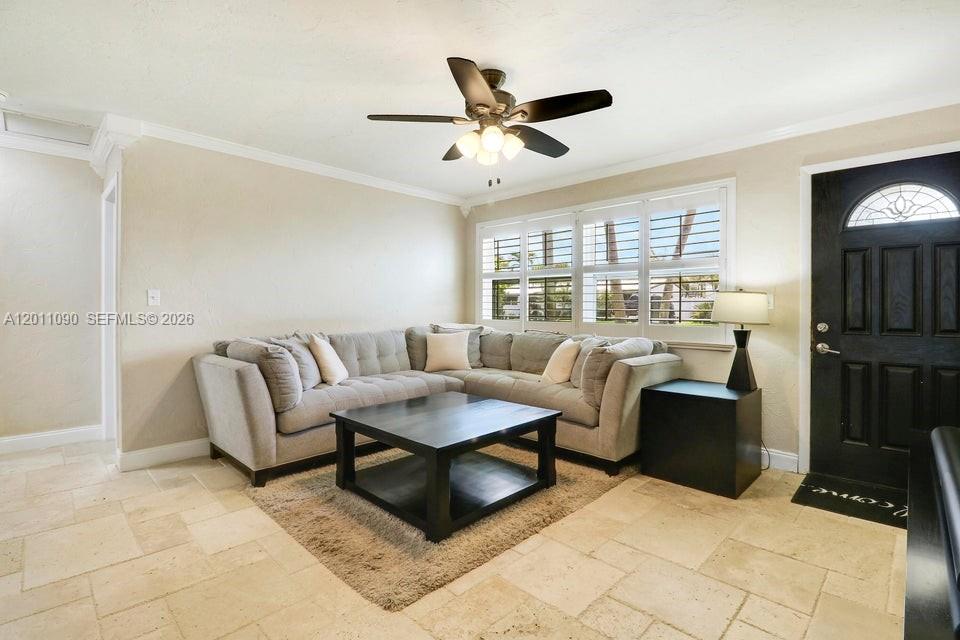A living room features a sectional sofa, a coffee table, and tile flooring — 19049 SE Robert Drive, Jupiter FL 33469, JUPITER, FL