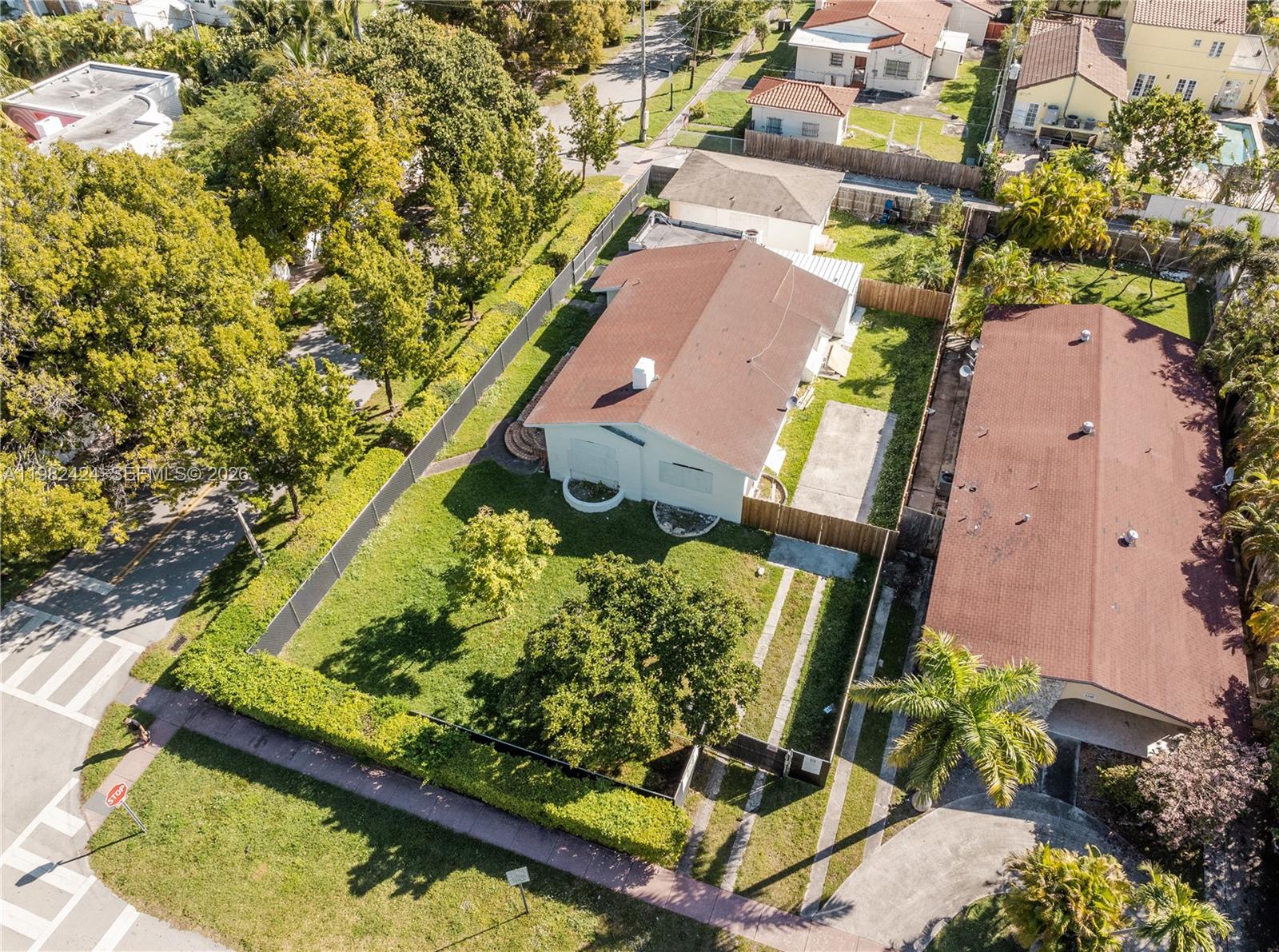 An aerial view shows a single-story house with a brown roof and a fenced yard — 1255 Lenox Ave, Miami Beach FL 33139, MIAMI BEACH, FL