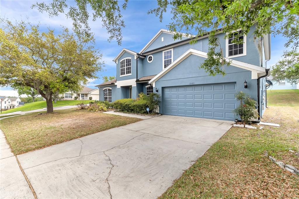 A two-story blue house with a two-car garage and a concrete driveway — 3323 FAWNWOOD DRIVE, OCOEE, FL