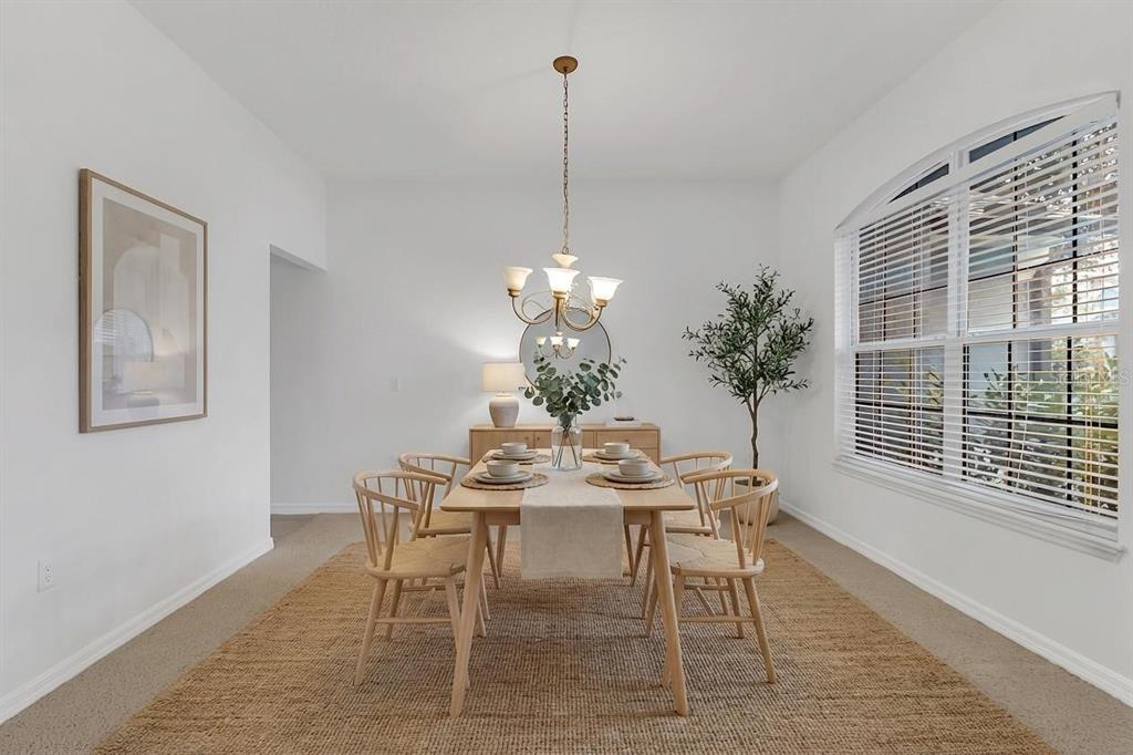 A dining room features a wooden table with six chairs, a chandelier, and a rug — 3323 FAWNWOOD DRIVE, OCOEE, FL