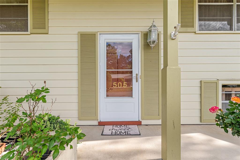 A front entrance features a white storm door with house number 505 and beige siding — 505 NW 37TH PLACE, GAINESVILLE, FL