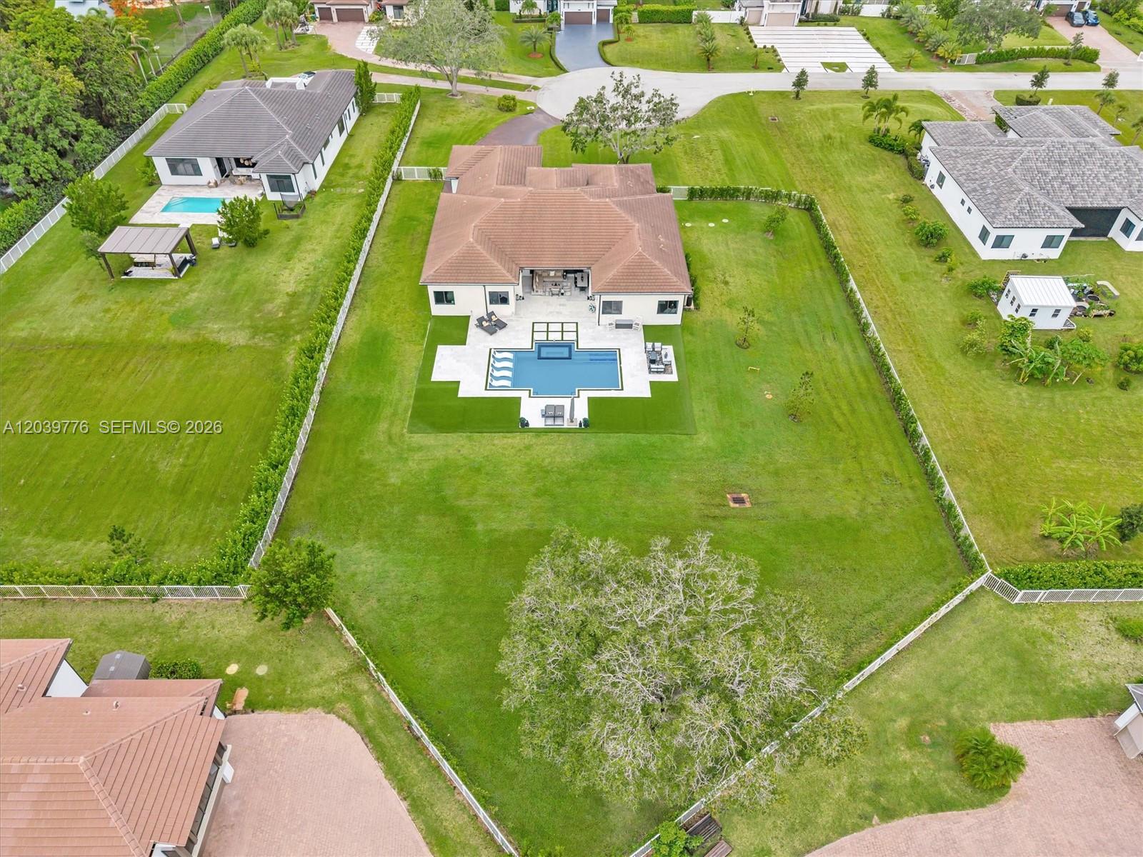 An aerial view shows a house with a pool and large yard inside a fence — 4980 SW 159th Ave, Southwest Ranches FL 33331, SOUTHWEST RANCHES, FL