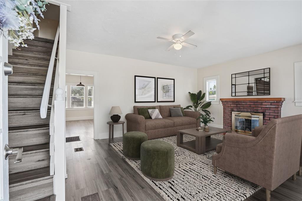 A living room features a white sofa, wooden coffee table, two chairs, and a staircase — 4026 4TH AVENUE S, ST PETERSBURG, FL