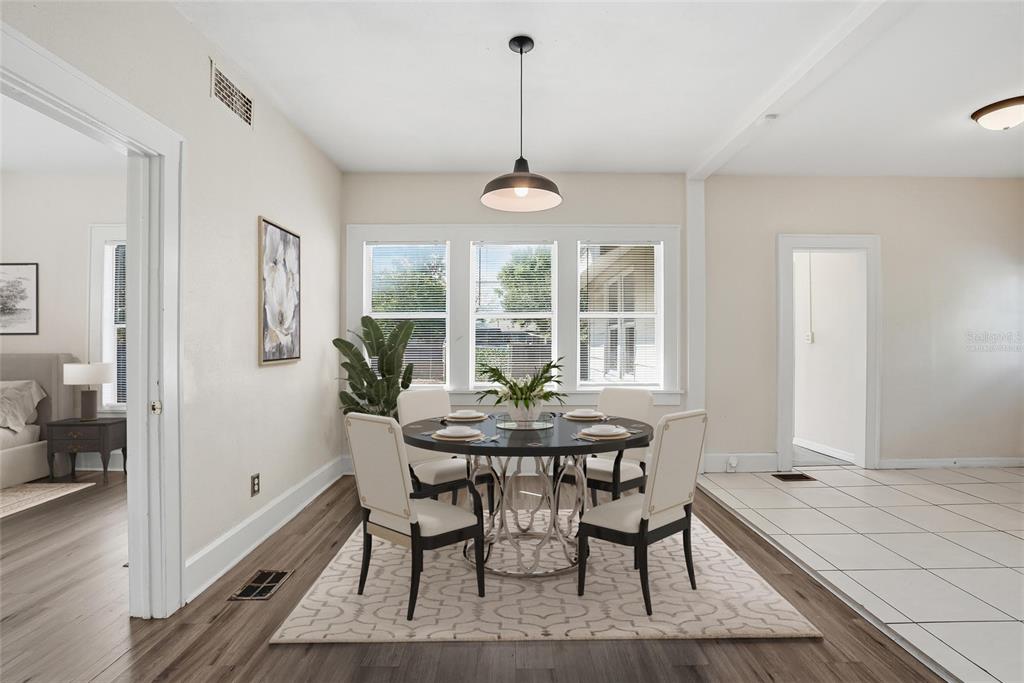A bedroom features a blue daybed, a floor mirror, and wood-look flooring under a ceiling fan — 4026 4TH AVENUE S, ST PETERSBURG, FL