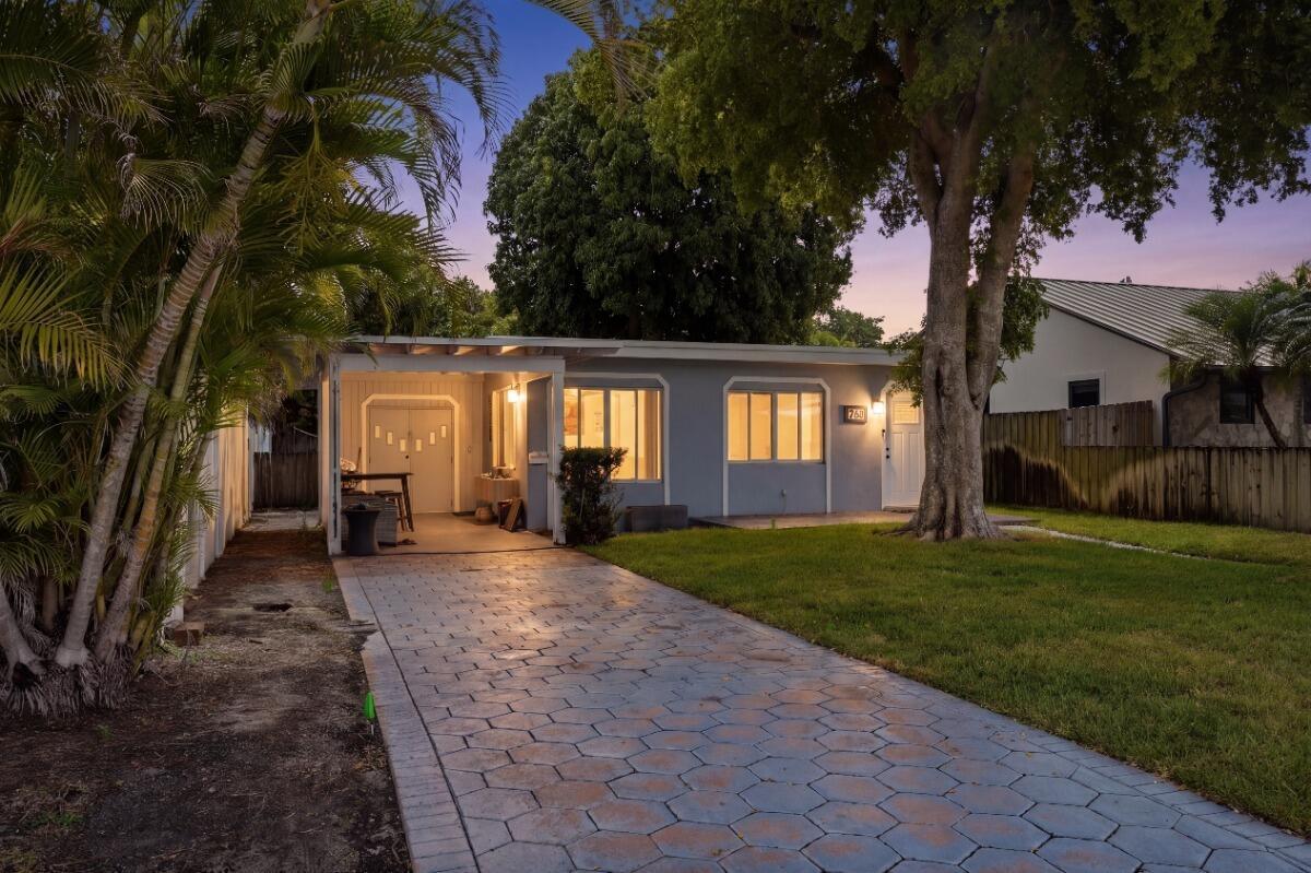A single-story house with a paved driveway, carport, and large tree in the front yard — 712 NE 10th Avenue, Pompano Beach FL 33060, POMPANO BEACH, FL